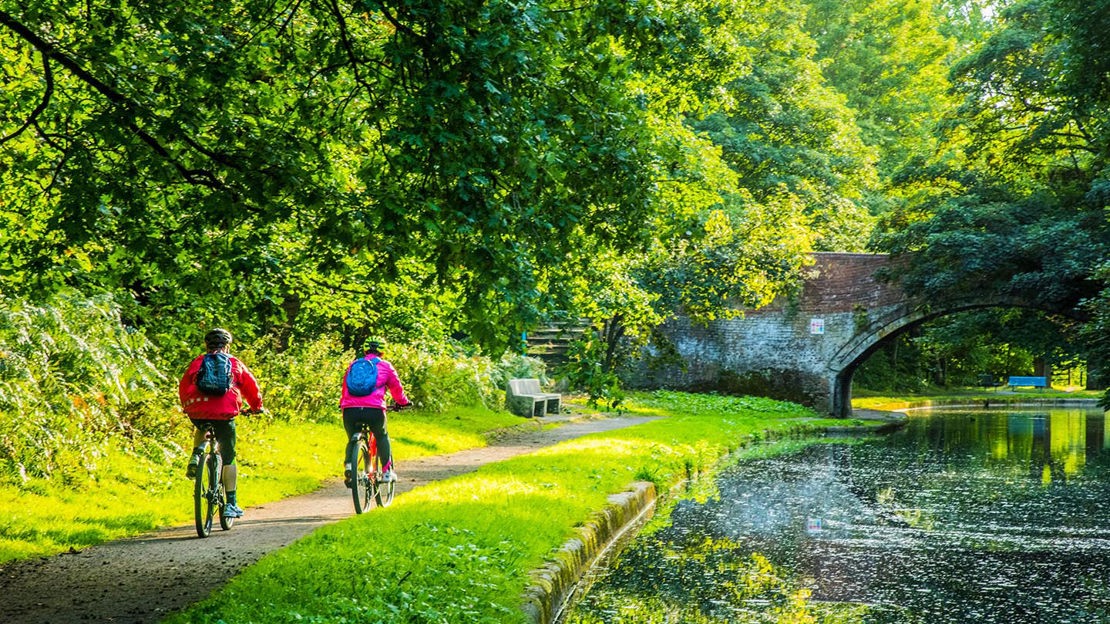 Pair of cyclists on canal tow path, Fountains Wood