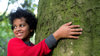 Boy hugging a tree