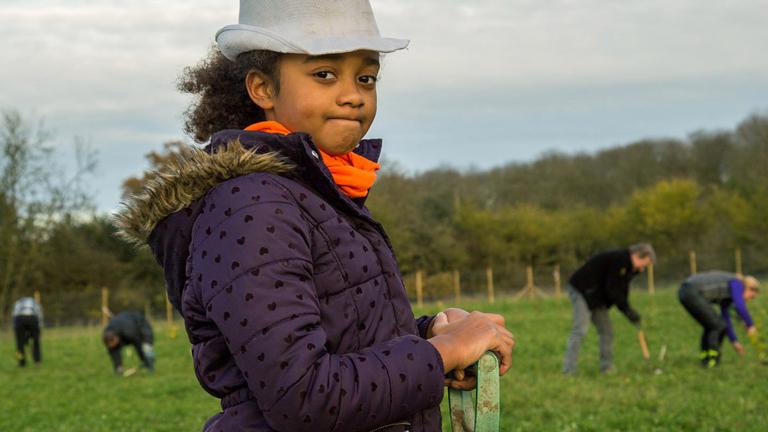 Girl holding the handle of a spade