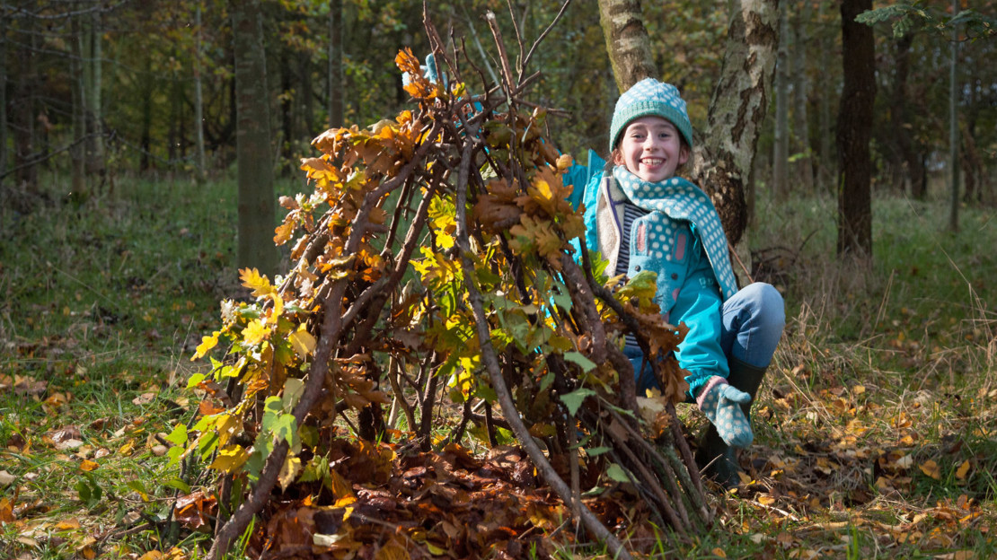 Girl building a den in Londonthorpe Woods