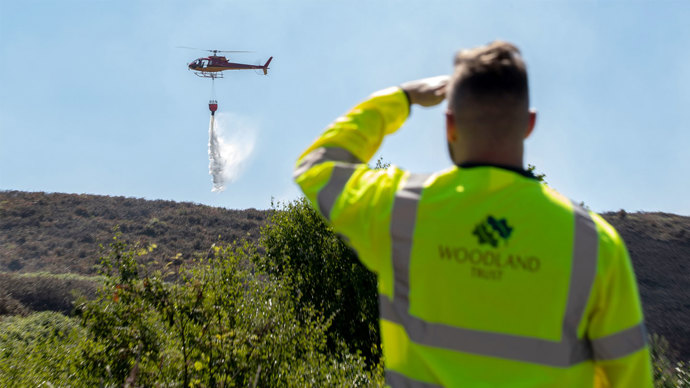 Helicopter dropping water on Winter Hill fire