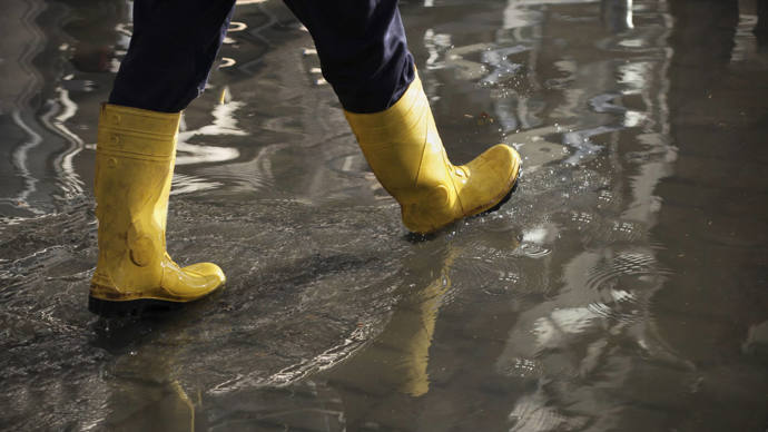 Wellies walking through a flooded street