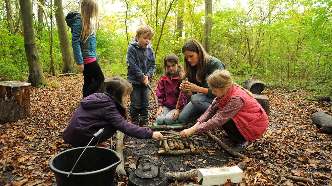 Forest school Kids Building Upside Down Campfire
