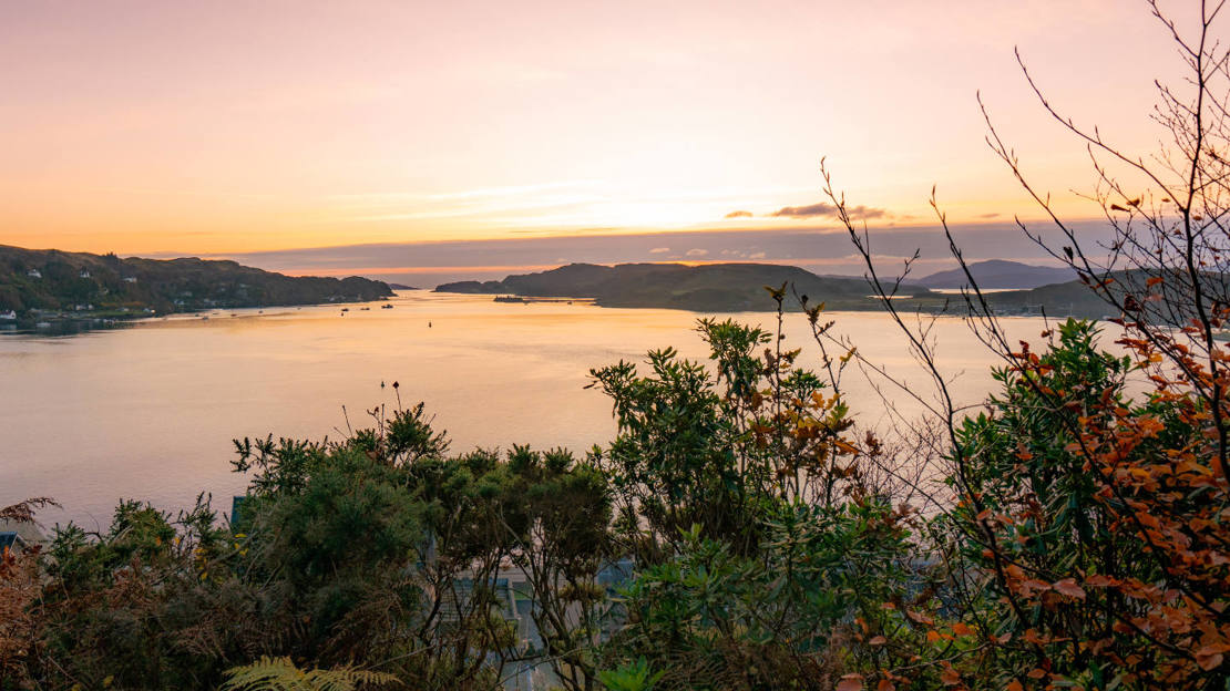 Sunset view over Oban Bay from Dunollie Wood