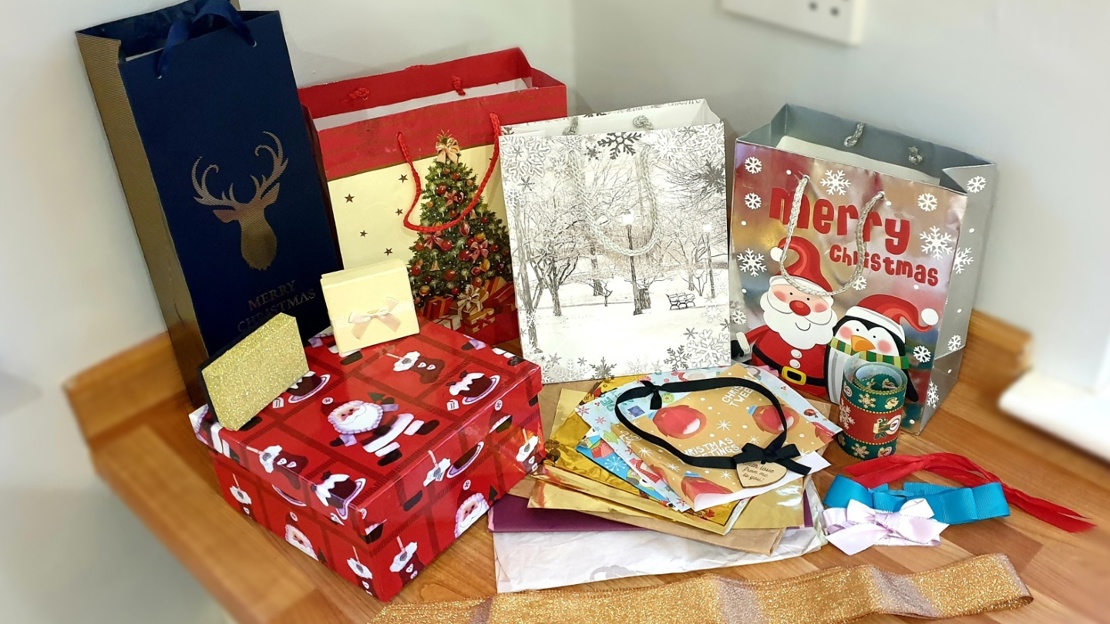 Selection of colourful Christmas bags, boxes, papers and ribbons