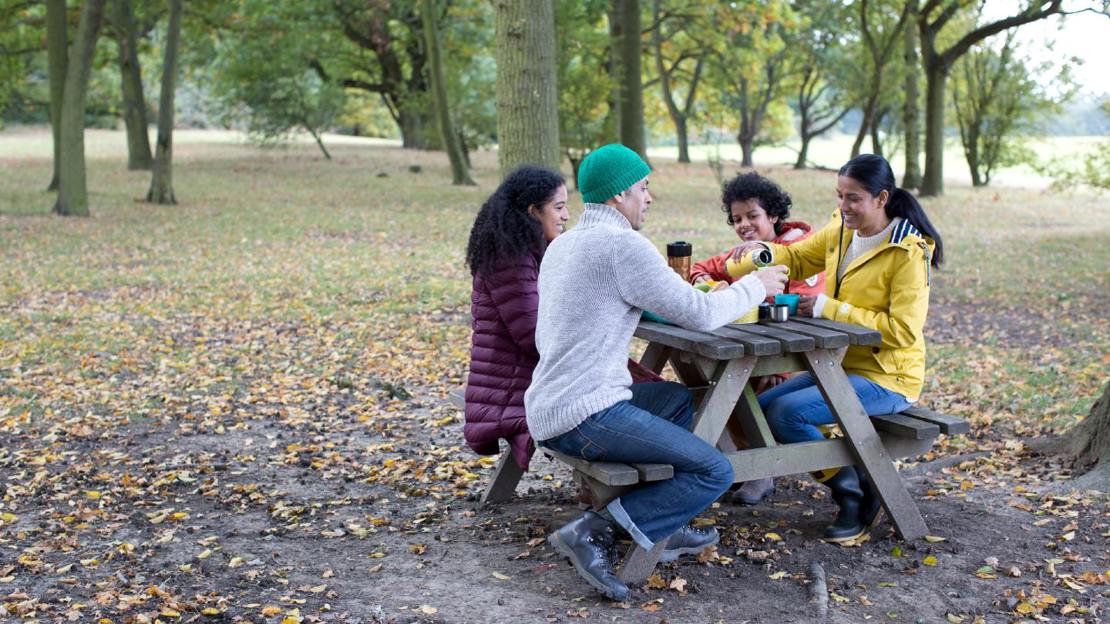 Family at picnic table in woodland