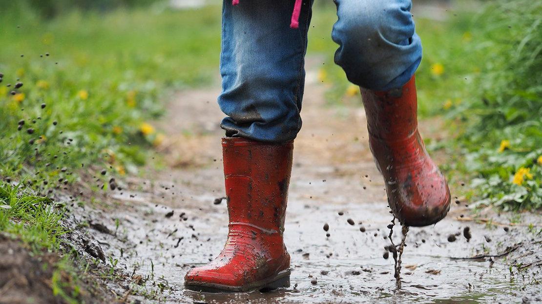 Child splashing in mud