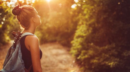 Young woman wandering around woodland