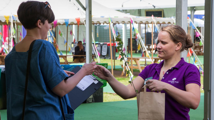 A Trust volunteer taking contact details from a supporter