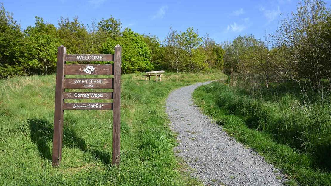 Entrance sign next to surfaced path
