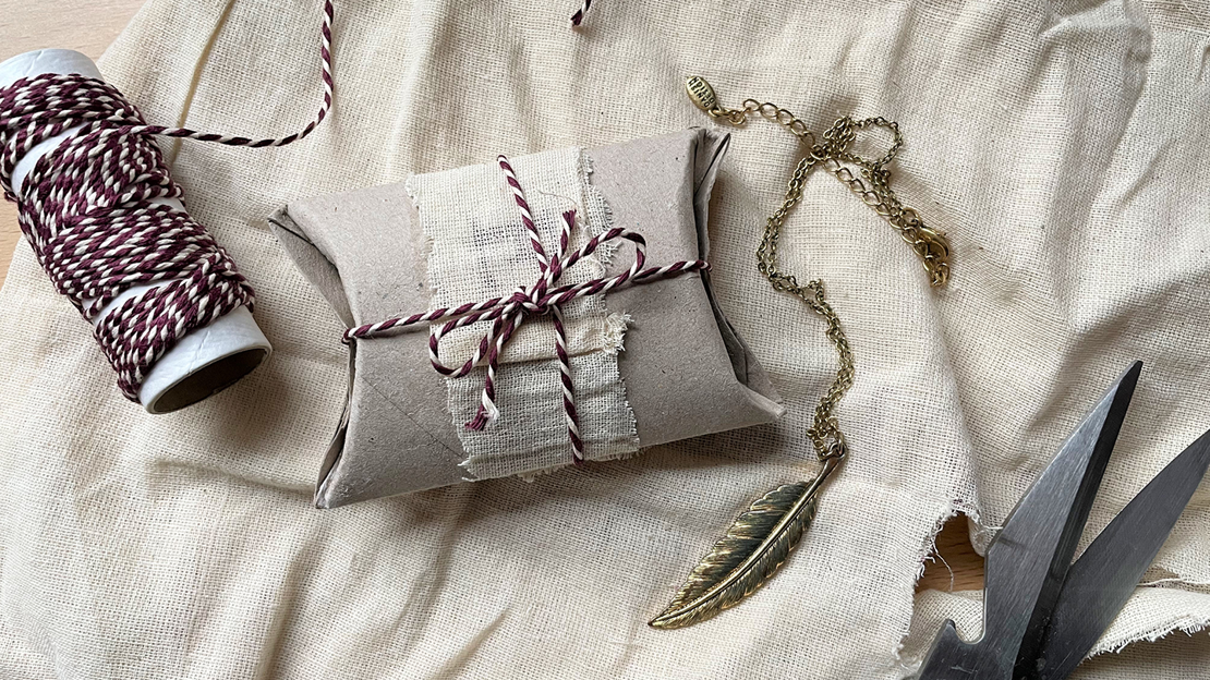 Cardboard tube made into a gift box tied with string