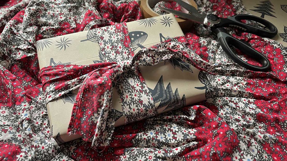 Christmas present tied with a ribbon made from floral fabric