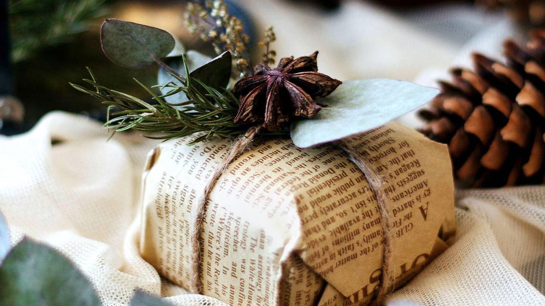 Christmas present wrapped in newspaper and string