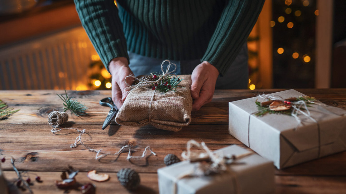 Christmas present wrapped with brown paper and pinecones