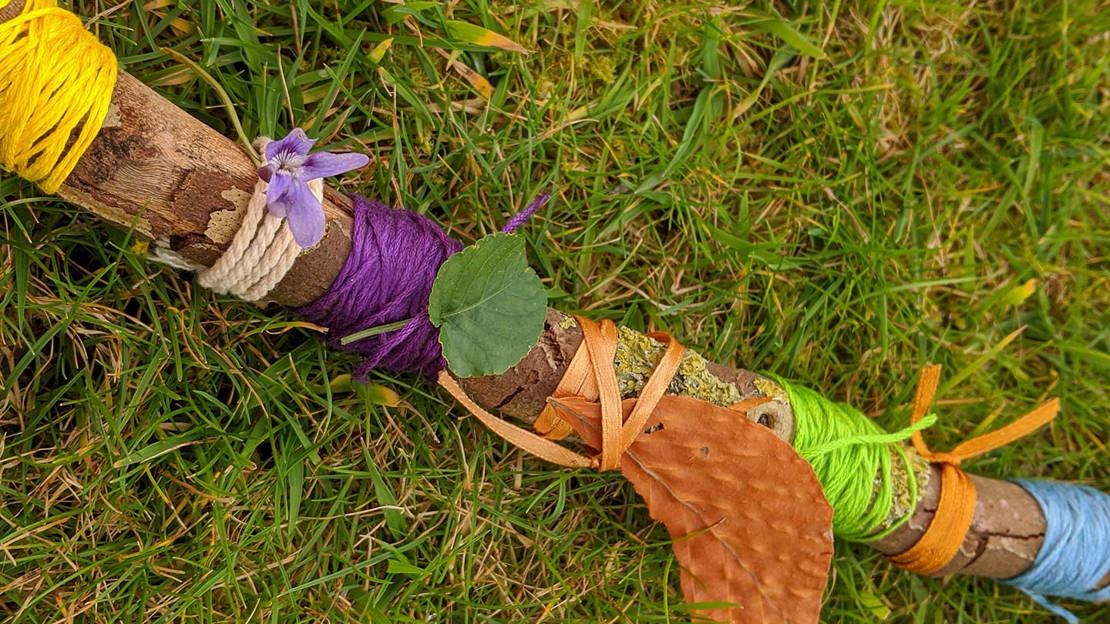 Coloured threads wrapped around a twig to make a journey stick