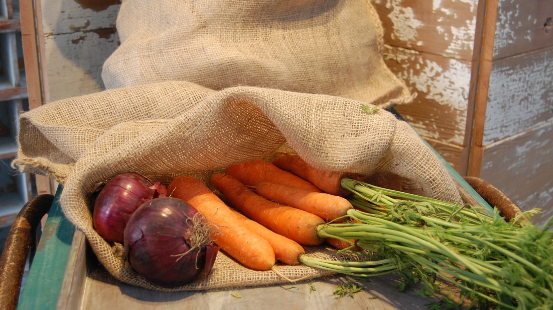 Jute sacks containing carrots and onions