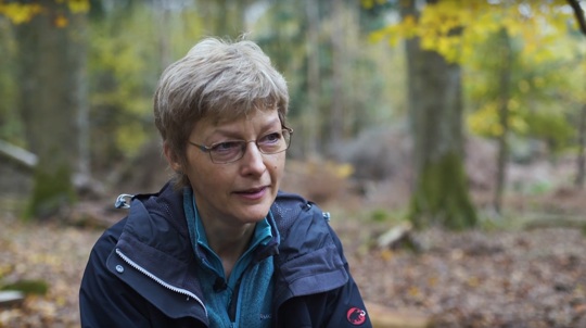 Volunteer Hilary Hinks in a wood talking to camera