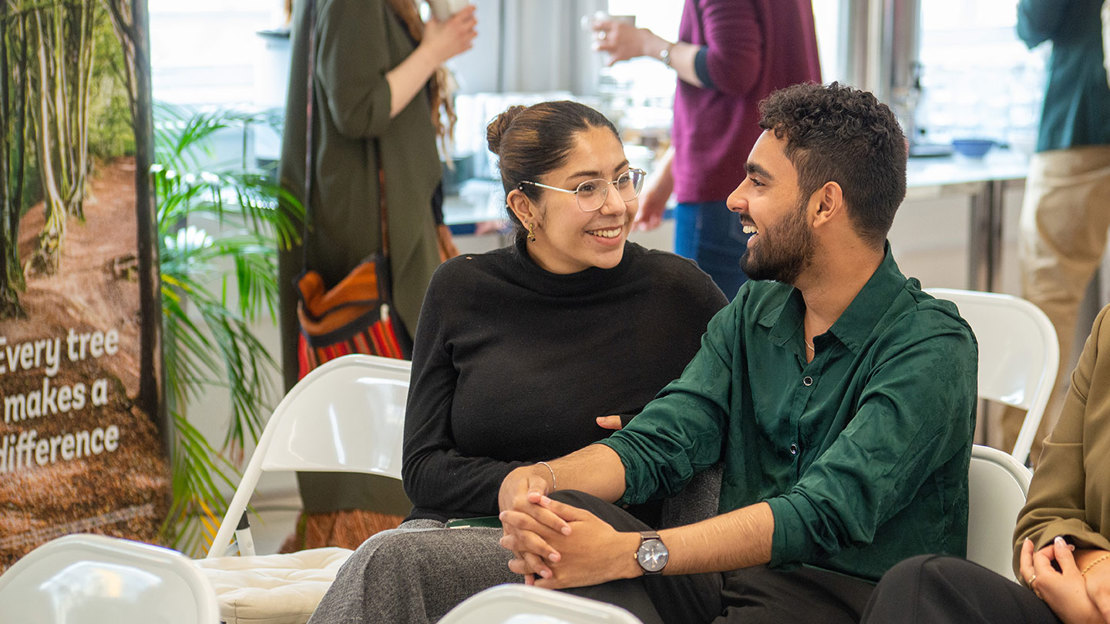 Moiz Siddiqi and Sana Mirza smiling in audience