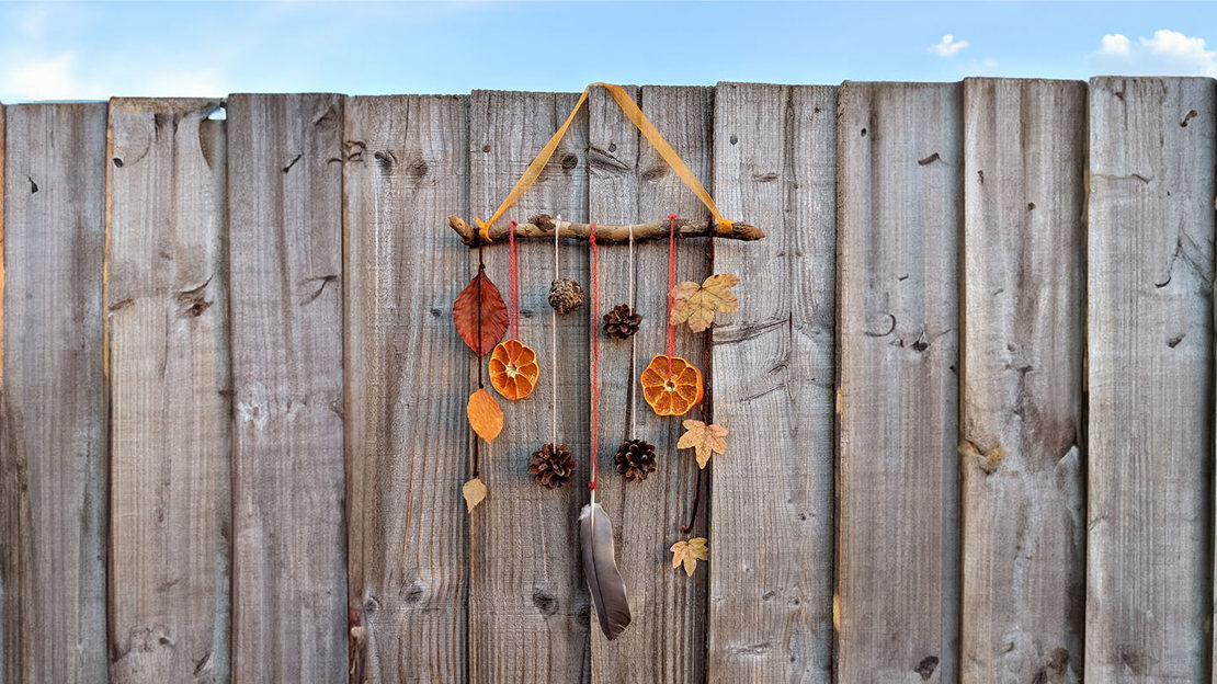 Leaf mobile hanging on a fence