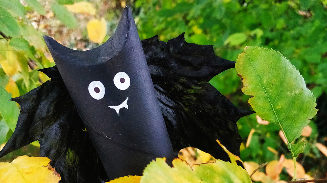 Model bat made from a painted cardboard tube and fallen leaf