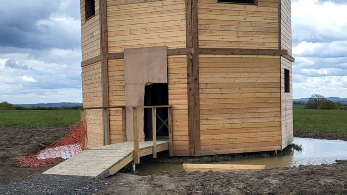 Wooden viewing platform with signs of vandalism.