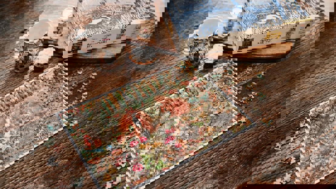 An almost-complete squirrel jigsaw laid on a wooden surface