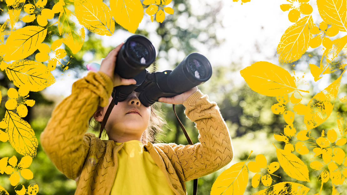 Girl with binoculars in woods