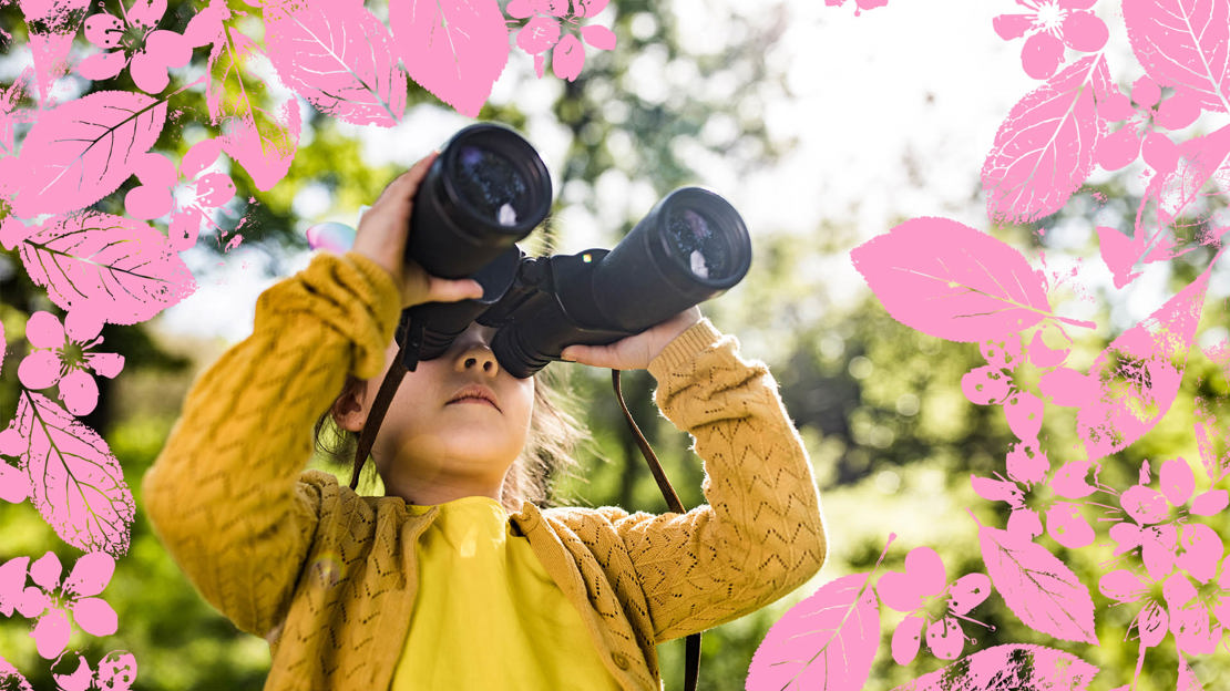 Girl with binoculars in woods