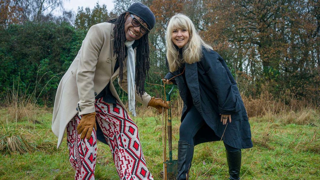 Nile Rodgers and partner Nancy Hunt posing for photo with shovel.