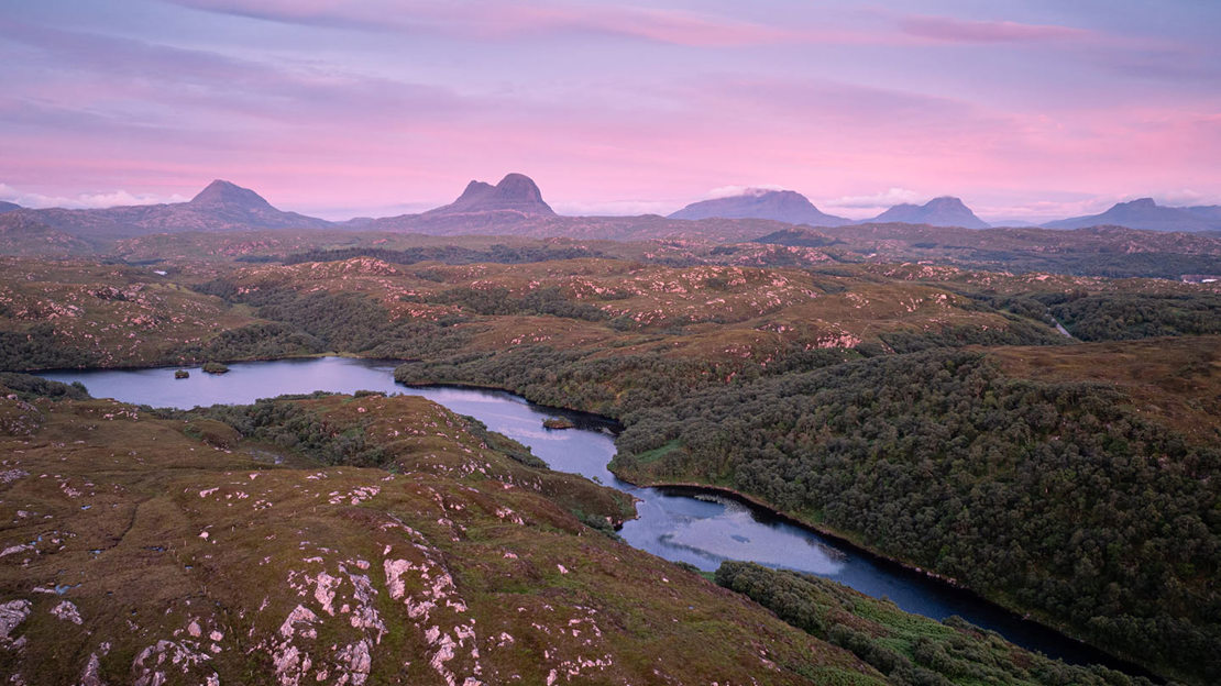 Row of five mountain peaks on the horizon.
