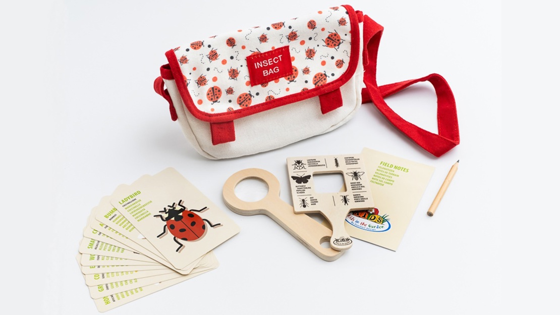 A red and white bag with magnifying glass, species cards and notebook