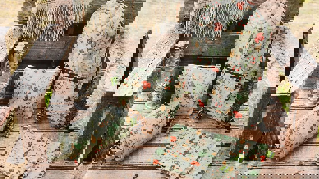 A backpack, pencil case and four rectangular bags laid on a wooden chair